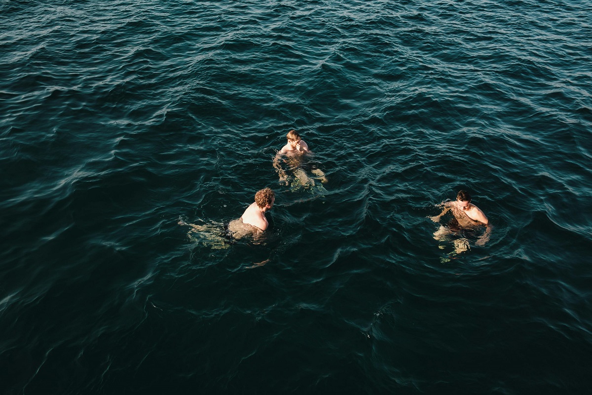 three men treading in water