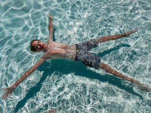 boy floating in a swimming pool