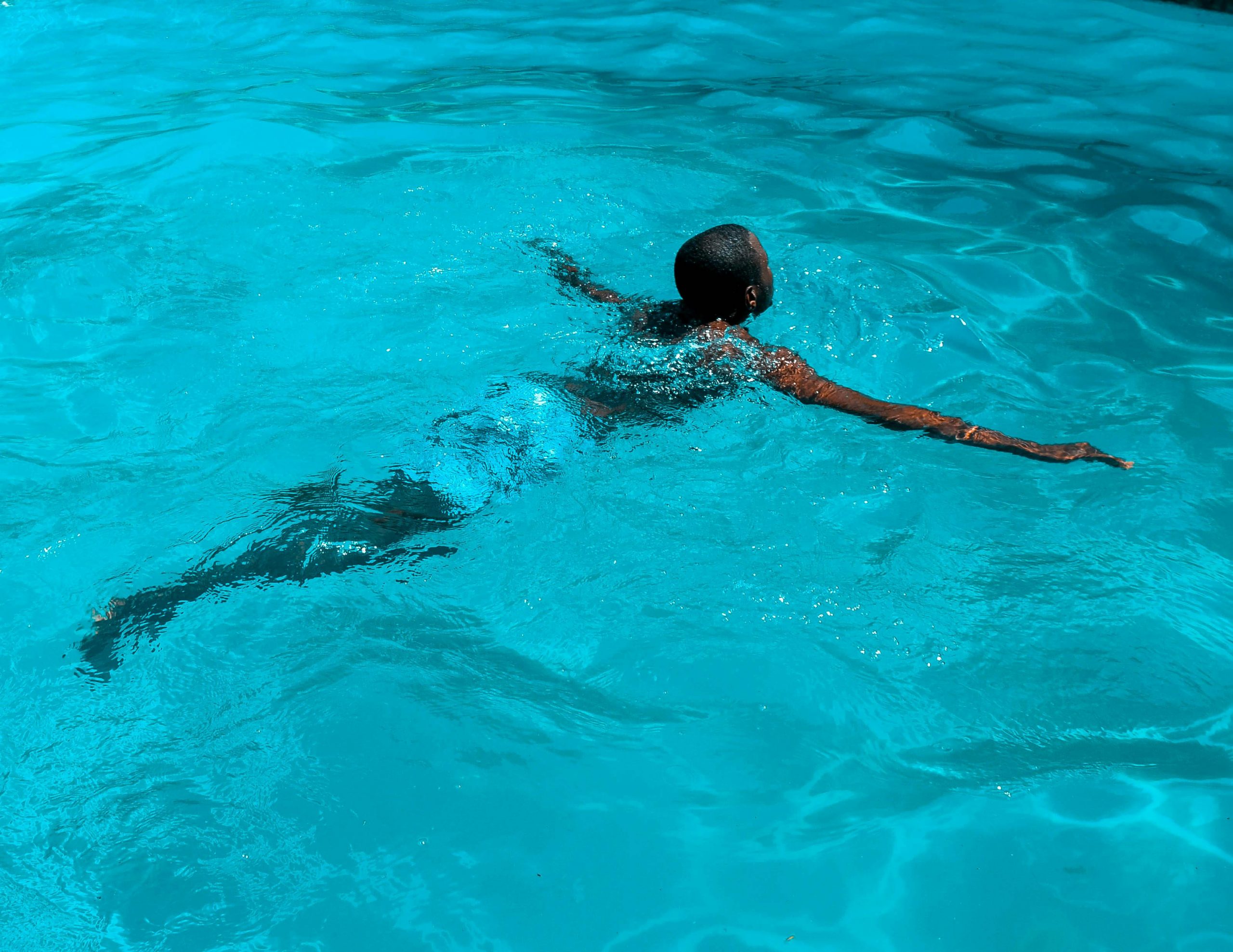 man doing a front float in a pool